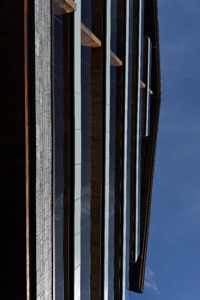 Rough-hewn wood paneling nods to traditional chalet construction – Six Senses Crans-Montana