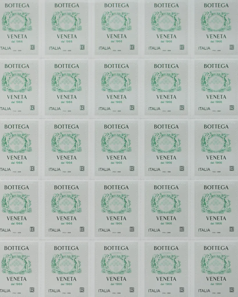 The commemorative stamp for the sixtieth year of Bottega Veneta, with the house crest in dark green and the motto Labor et Ingenium. Courtesy Bottega Veneta