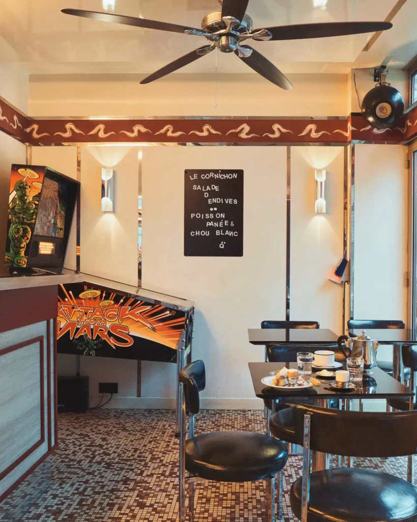 Green velvet banquettes and a mosaic floor, interiors by Claves